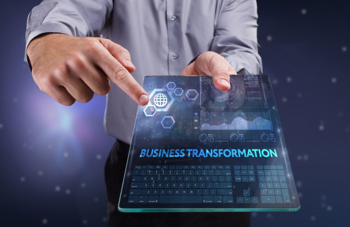 The concept of business, technology, the Internet and the network. A young entrepreneur working on a virtual screen of the future and sees the inscription: Business transformation